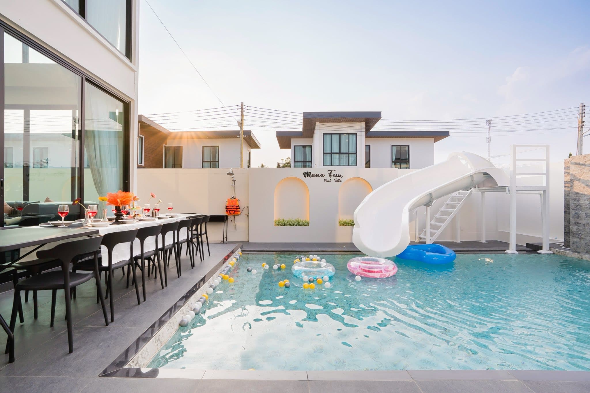 Luxury pool villa exterior at night with lighting