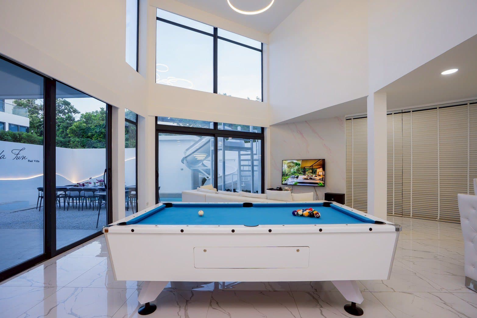 Private swimming pool with inflatable toys in family pool villa